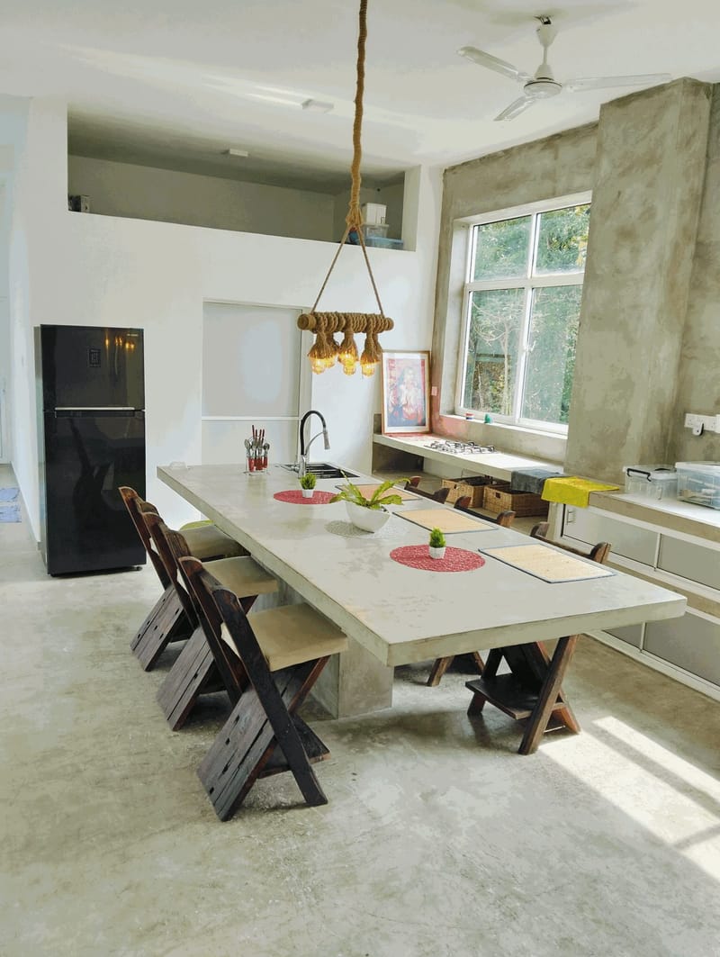 Open-plan kitchen at Villa Idda with a long dining table seating ten guests